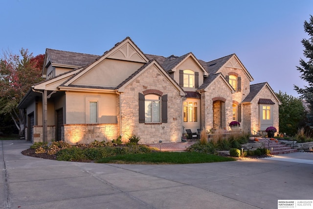 french country inspired facade featuring a garage