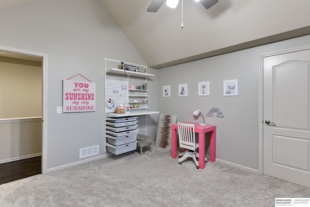 interior space featuring ceiling fan, vaulted ceiling, and light carpet