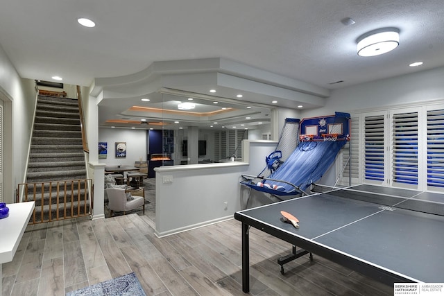 recreation room with wood-type flooring