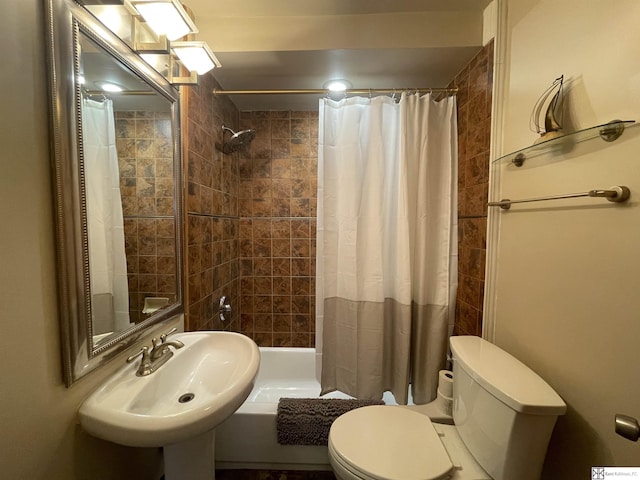 full bathroom featuring shower / bathtub combination with curtain, sink, and toilet