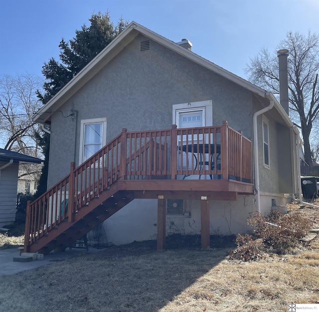back of house with a wooden deck