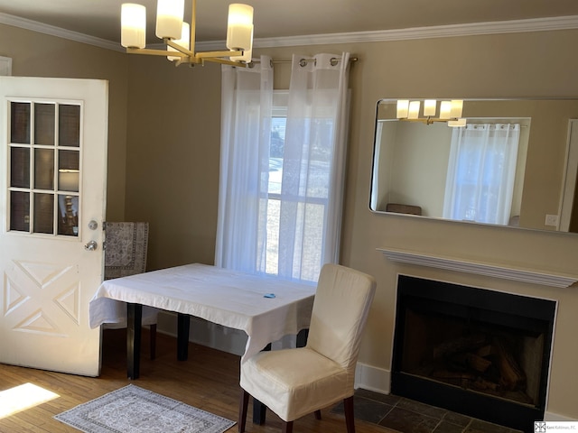 dining area featuring an inviting chandelier, ornamental molding, and wood-type flooring