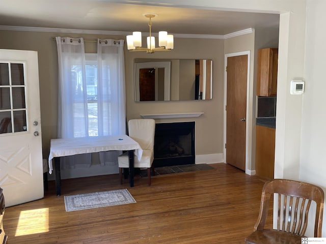 dining space with ornamental molding, dark wood-type flooring, and a chandelier