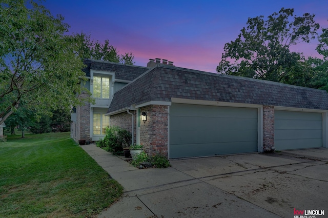 view of front of house with a garage and a yard