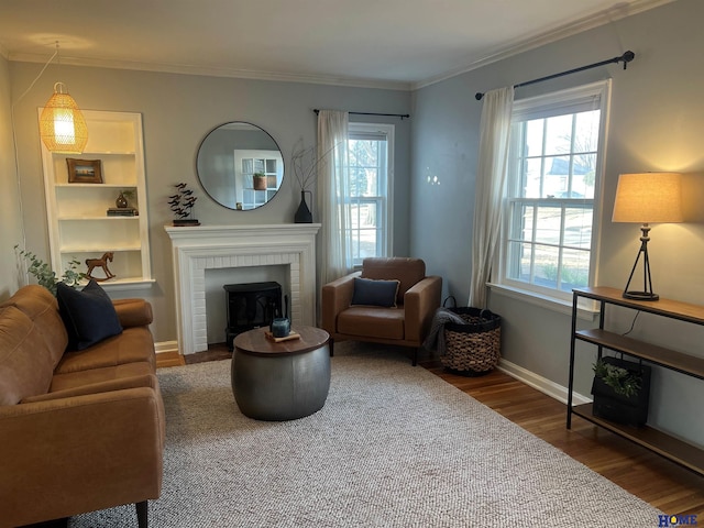 living room with hardwood / wood-style floors, crown molding, and plenty of natural light