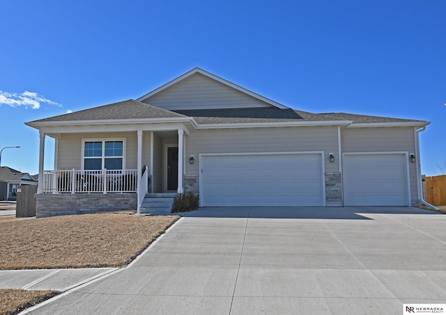 ranch-style home with a garage and covered porch