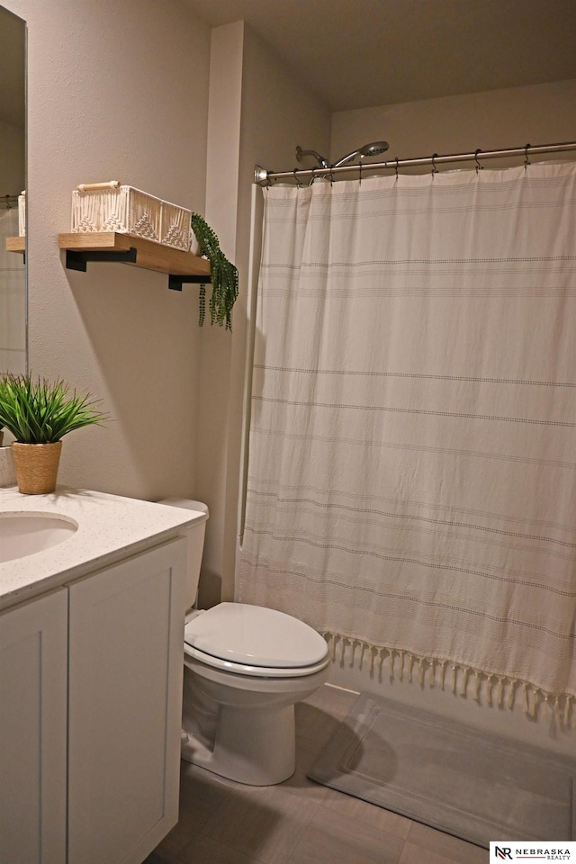 bathroom with vanity, toilet, and a shower with curtain