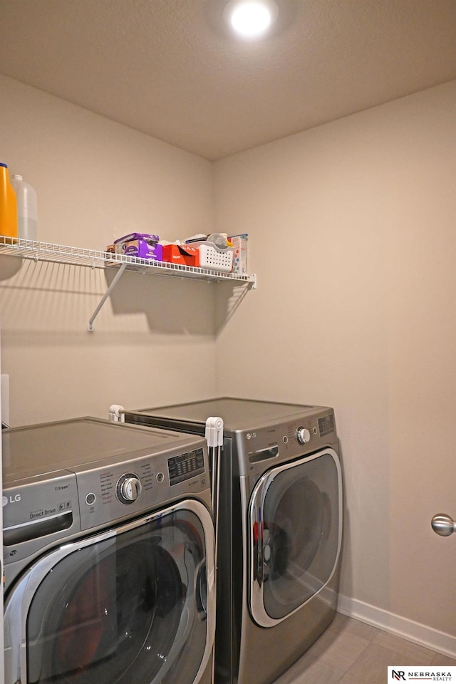 laundry room with separate washer and dryer and tile patterned flooring