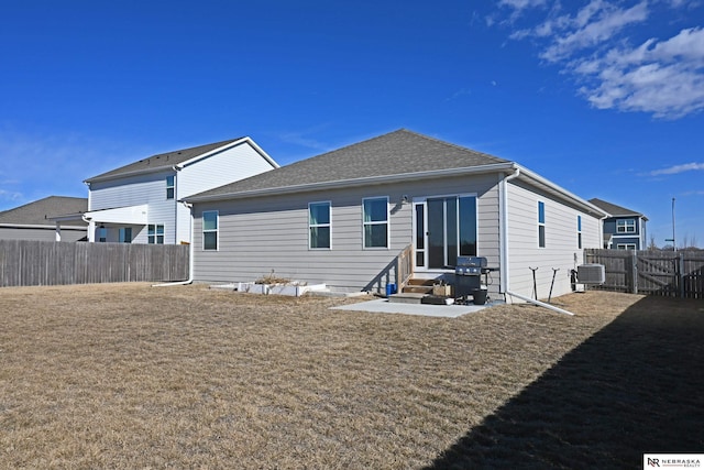 rear view of house with a patio, central AC unit, and a lawn