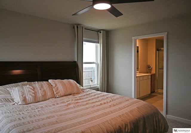 bedroom featuring connected bathroom, light colored carpet, and ceiling fan