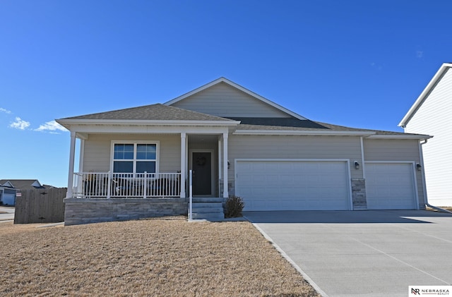 single story home featuring a garage and covered porch