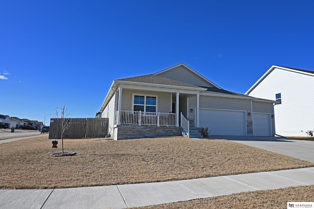 single story home with a garage and covered porch