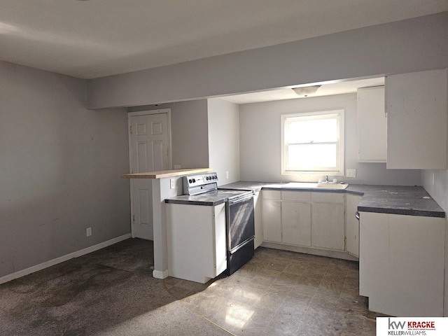 kitchen with electric stove, sink, white cabinets, and kitchen peninsula