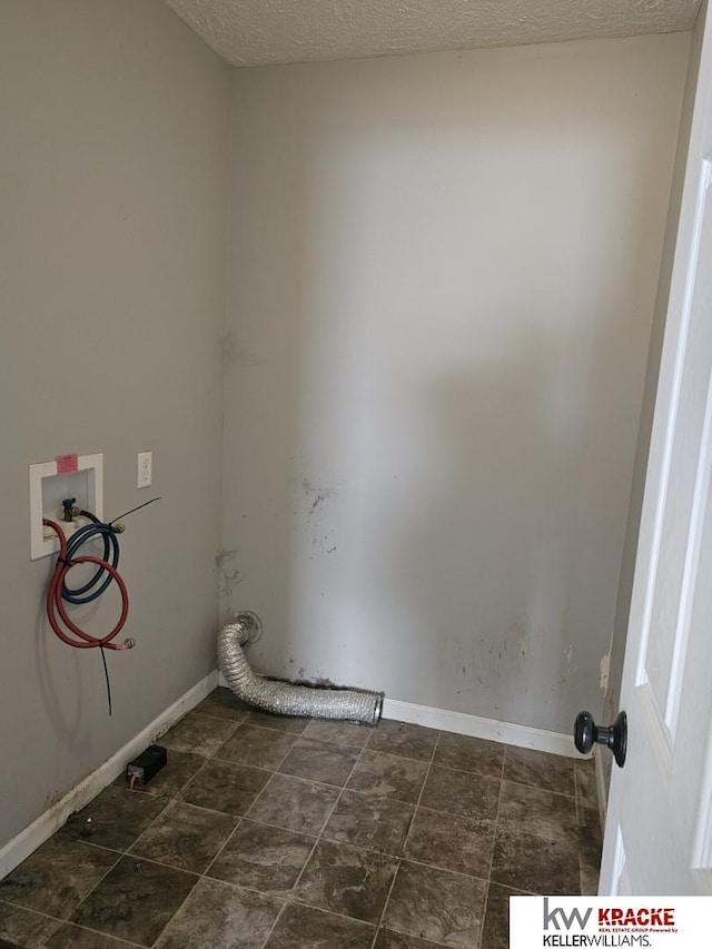 laundry area featuring hookup for a washing machine and a textured ceiling