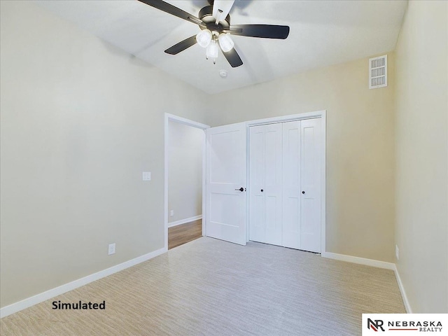 unfurnished bedroom featuring ceiling fan, carpet flooring, visible vents, baseboards, and a closet