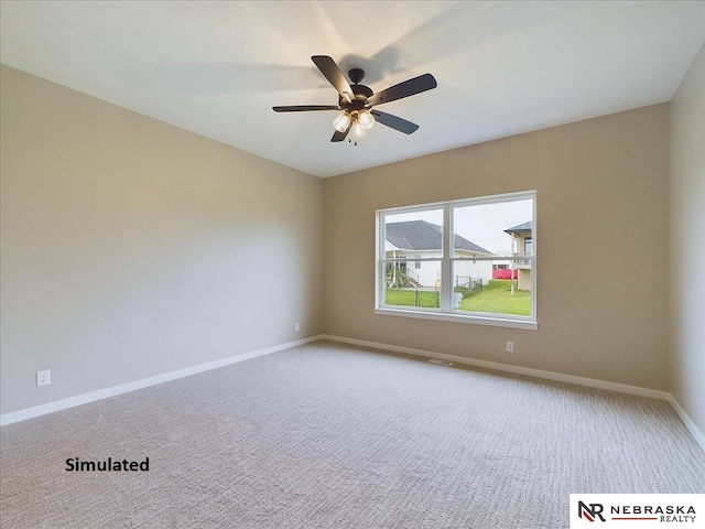 spare room featuring ceiling fan and carpet flooring