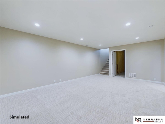 finished basement with recessed lighting, visible vents, light carpet, baseboards, and stairs