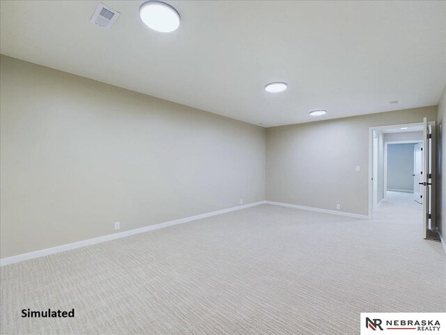 unfurnished room featuring baseboards, visible vents, and light colored carpet