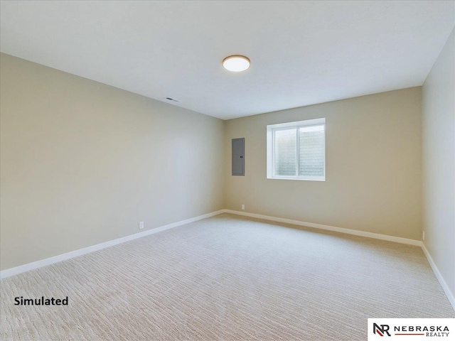 spare room with light carpet, visible vents, electric panel, and baseboards