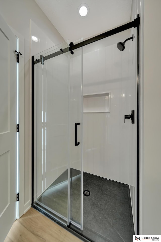 full bathroom with a shower stall, wood finished floors, and recessed lighting