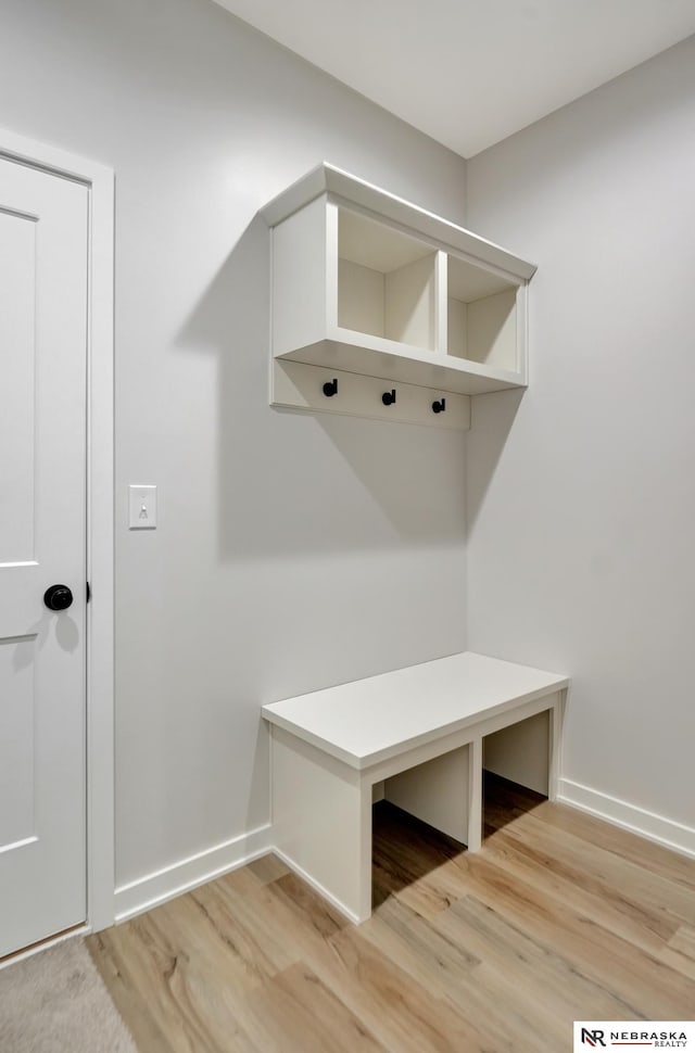 mudroom with light wood-style flooring and baseboards