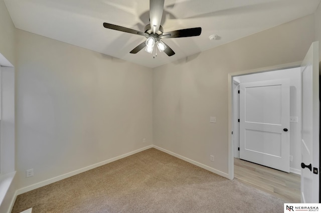 unfurnished room featuring light colored carpet, ceiling fan, and baseboards