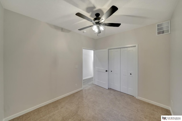 unfurnished bedroom with baseboards, visible vents, and carpet flooring