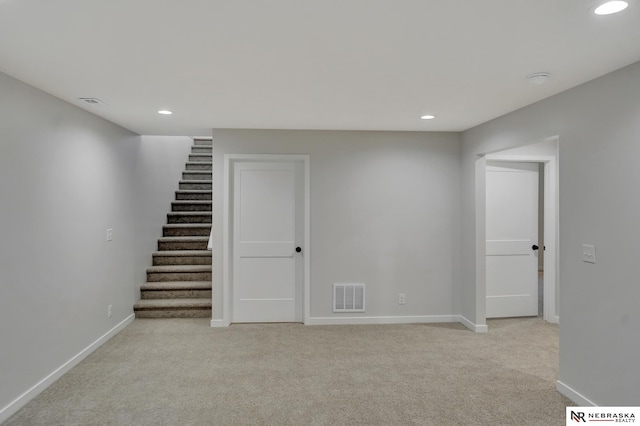 basement featuring recessed lighting, visible vents, light carpet, and baseboards