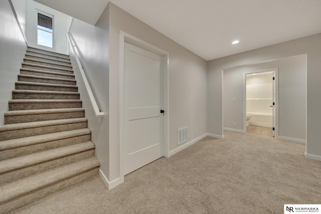 stairway featuring carpet floors, recessed lighting, visible vents, and baseboards