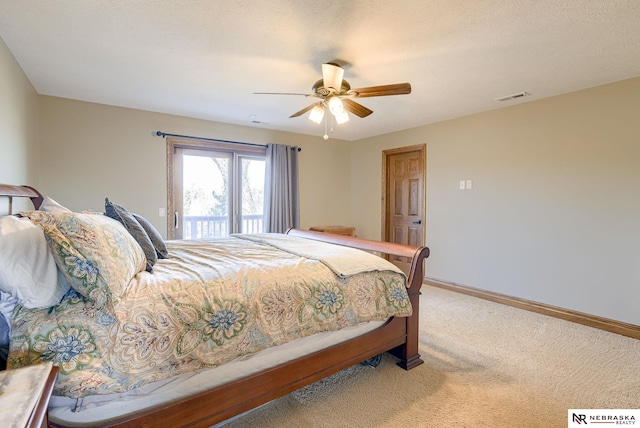 bedroom featuring a textured ceiling, access to outside, ceiling fan, and carpet