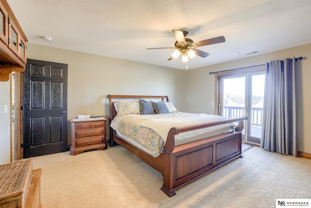 bedroom featuring ceiling fan, a textured ceiling, carpet, and access to outside