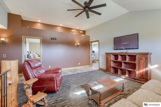 living room with vaulted ceiling, light hardwood / wood-style floors, and ceiling fan