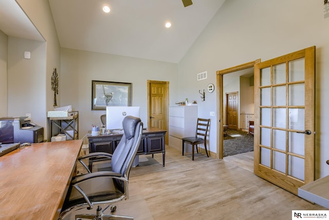 office space featuring light hardwood / wood-style flooring and high vaulted ceiling