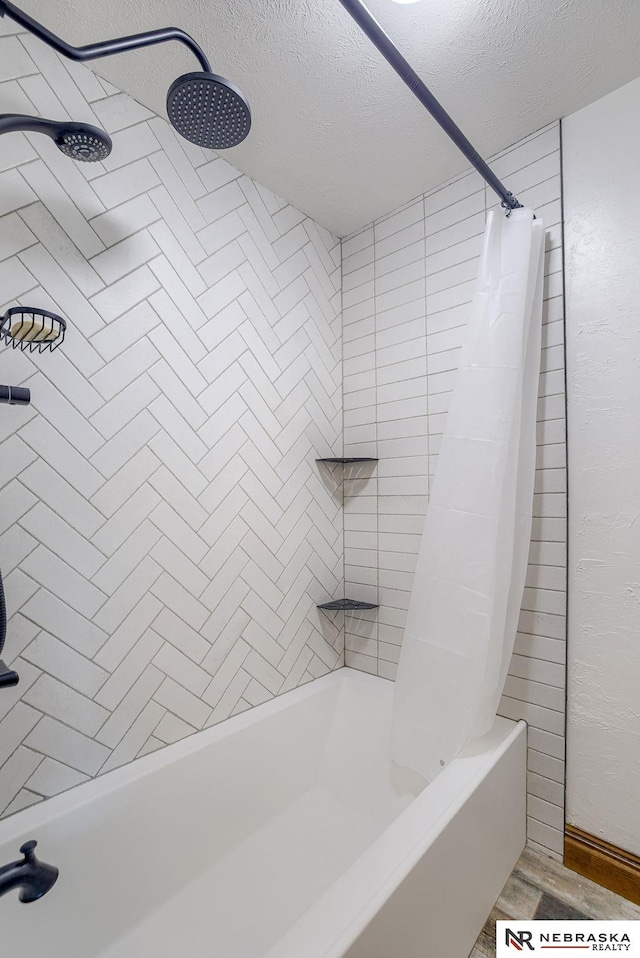 bathroom with hardwood / wood-style flooring and a textured ceiling