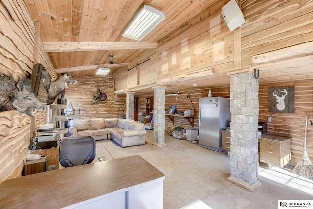 living room featuring beam ceiling, wooden ceiling, wood walls, and ornate columns