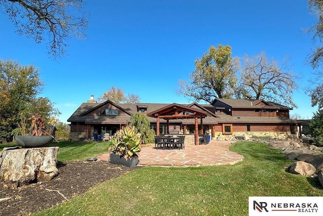 rear view of property with a patio area and a lawn