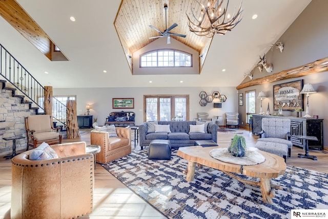 living room with ceiling fan, high vaulted ceiling, and light hardwood / wood-style floors