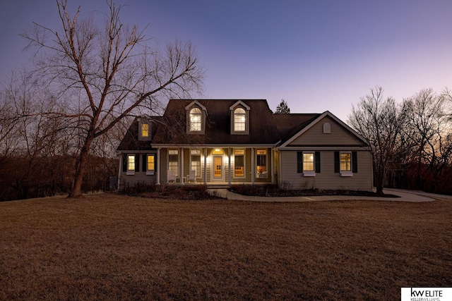 new england style home featuring a porch