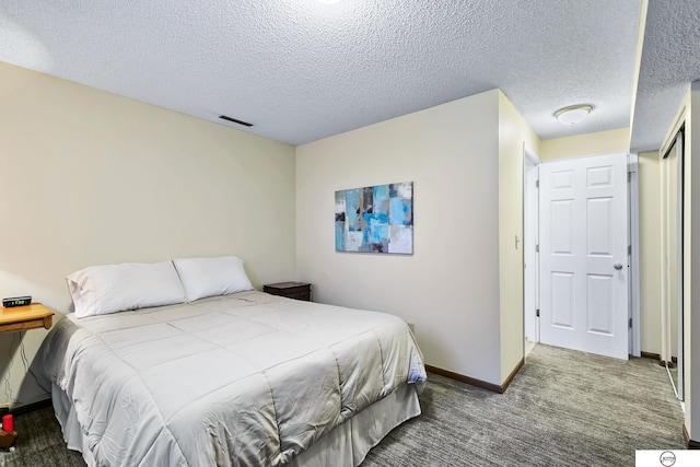 bedroom with a textured ceiling and carpet