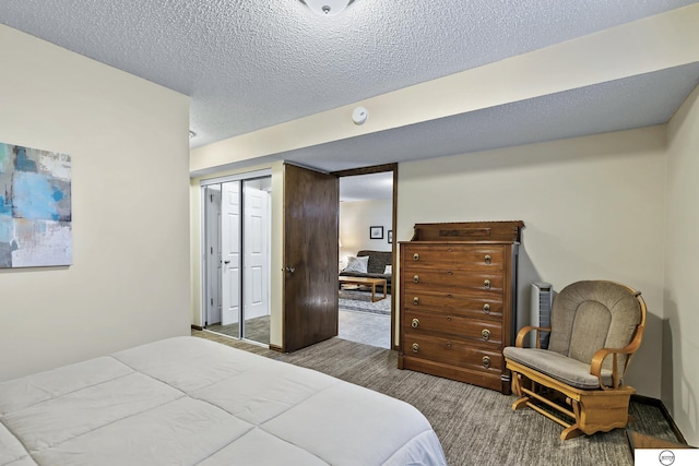 bedroom featuring a closet, carpet floors, and a textured ceiling