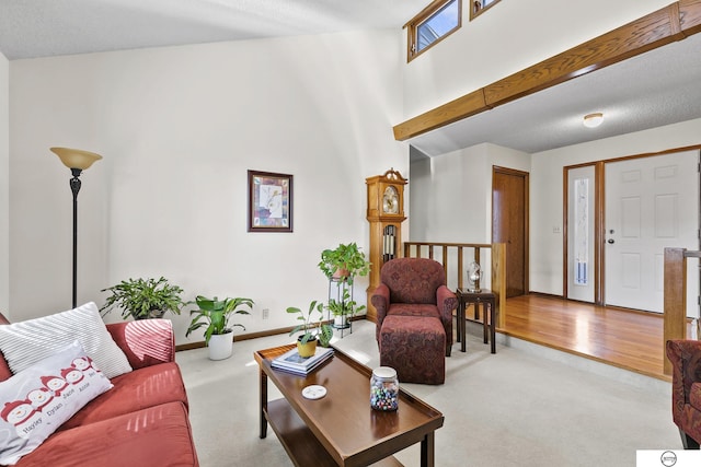 carpeted living room featuring a high ceiling