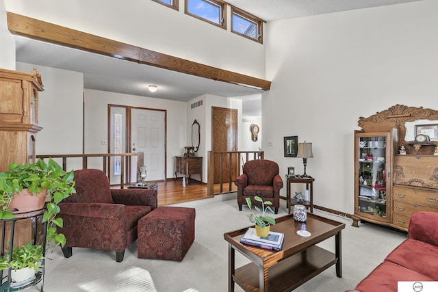 carpeted living room with a towering ceiling