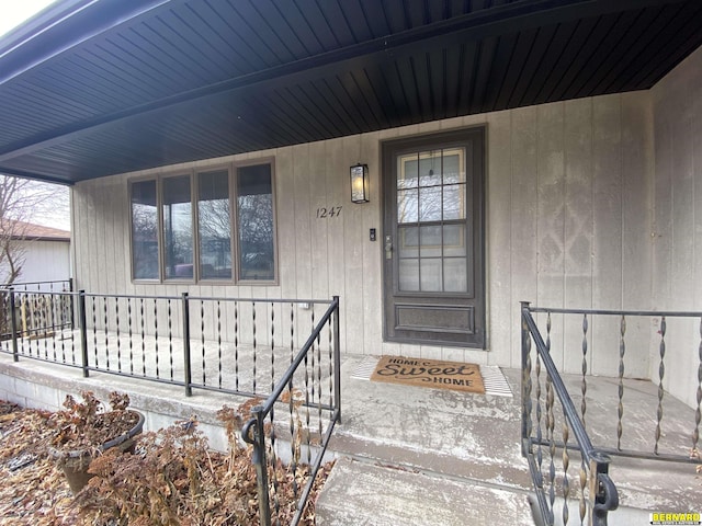 view of exterior entry featuring a porch