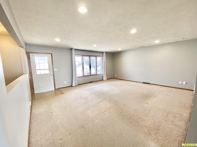 unfurnished living room with light carpet