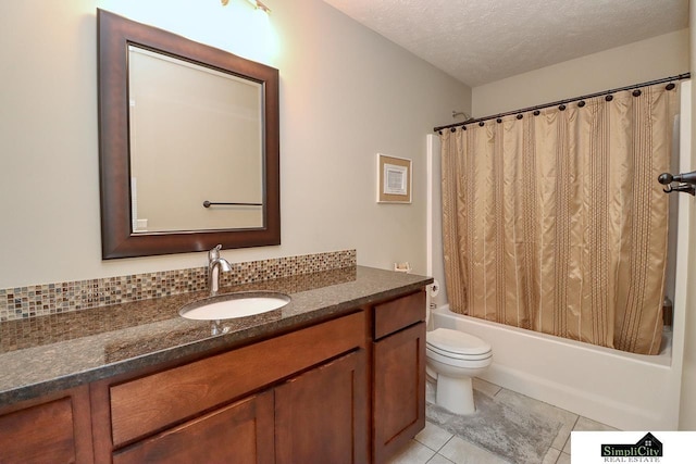 full bathroom featuring shower / tub combo with curtain, tile patterned flooring, vanity, a textured ceiling, and toilet