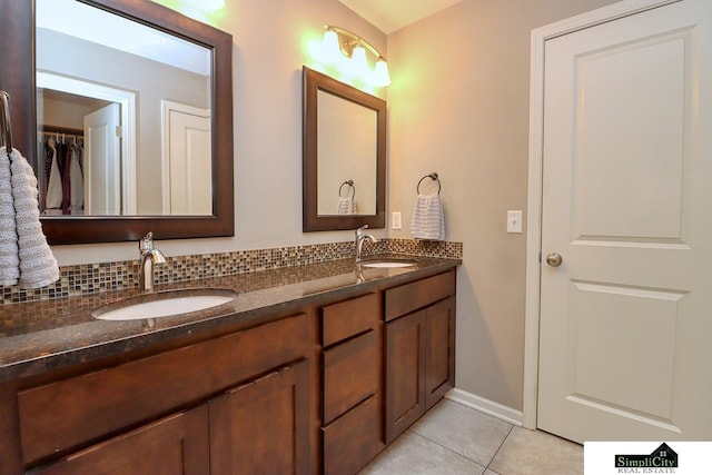 bathroom with tile patterned flooring, vanity, and tasteful backsplash