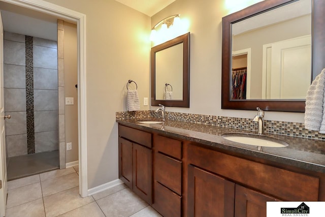 bathroom featuring tile patterned floors, vanity, and backsplash