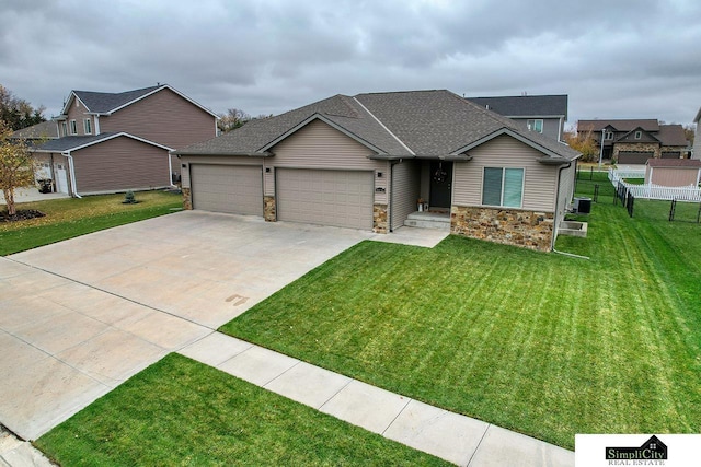 craftsman inspired home featuring a garage, a front lawn, and central air condition unit