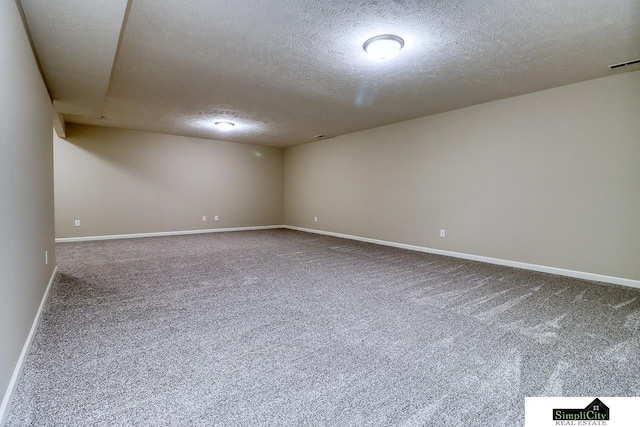 spare room featuring carpet floors and a textured ceiling