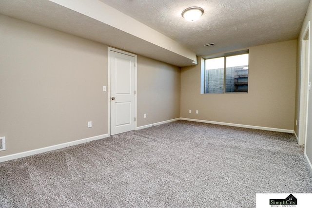 empty room featuring carpet floors and a textured ceiling